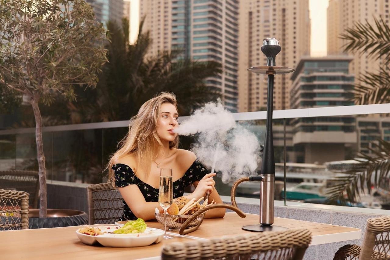 Crowne Plaza Dubai Marina By Ihg Hotel Bagian luar foto A woman smoking a hookah
